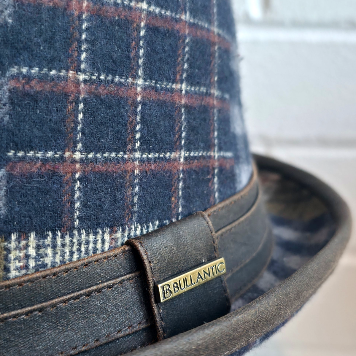 Close-up of the windowpane check and brown band with Bullantic bar badge